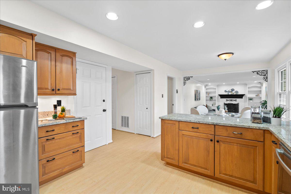 7596 Ruxton Drive Springfield, VA 22153 - Photo 5 of 40 a kitchen with white cabinets and stainless steel appliances