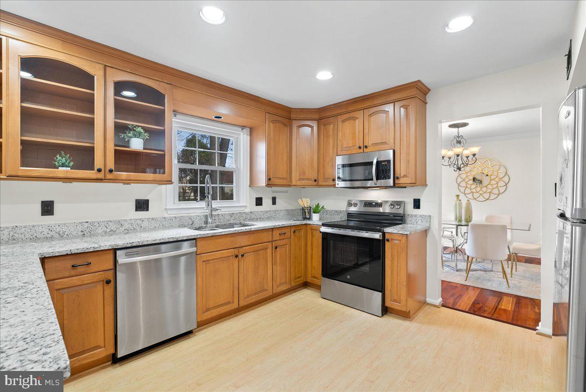 7596 Ruxton Drive Springfield, VA 22153 - Photo 6 of 40 a kitchen with stainless steel appliances granite countertop a stove sink and microwave
