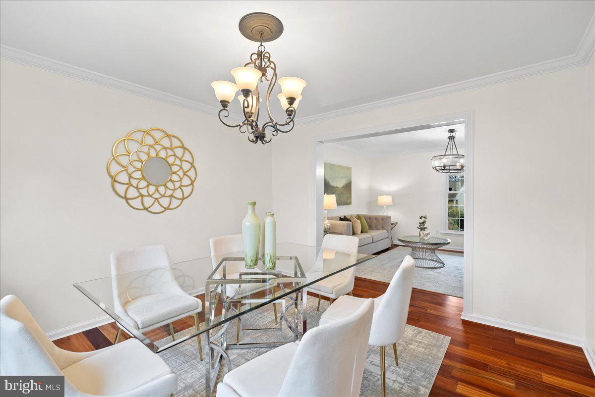 7596 Ruxton Drive Springfield, VA 22153 - Photo 7 of 40 a view of a dining room with furniture a chandelier and wooden floor