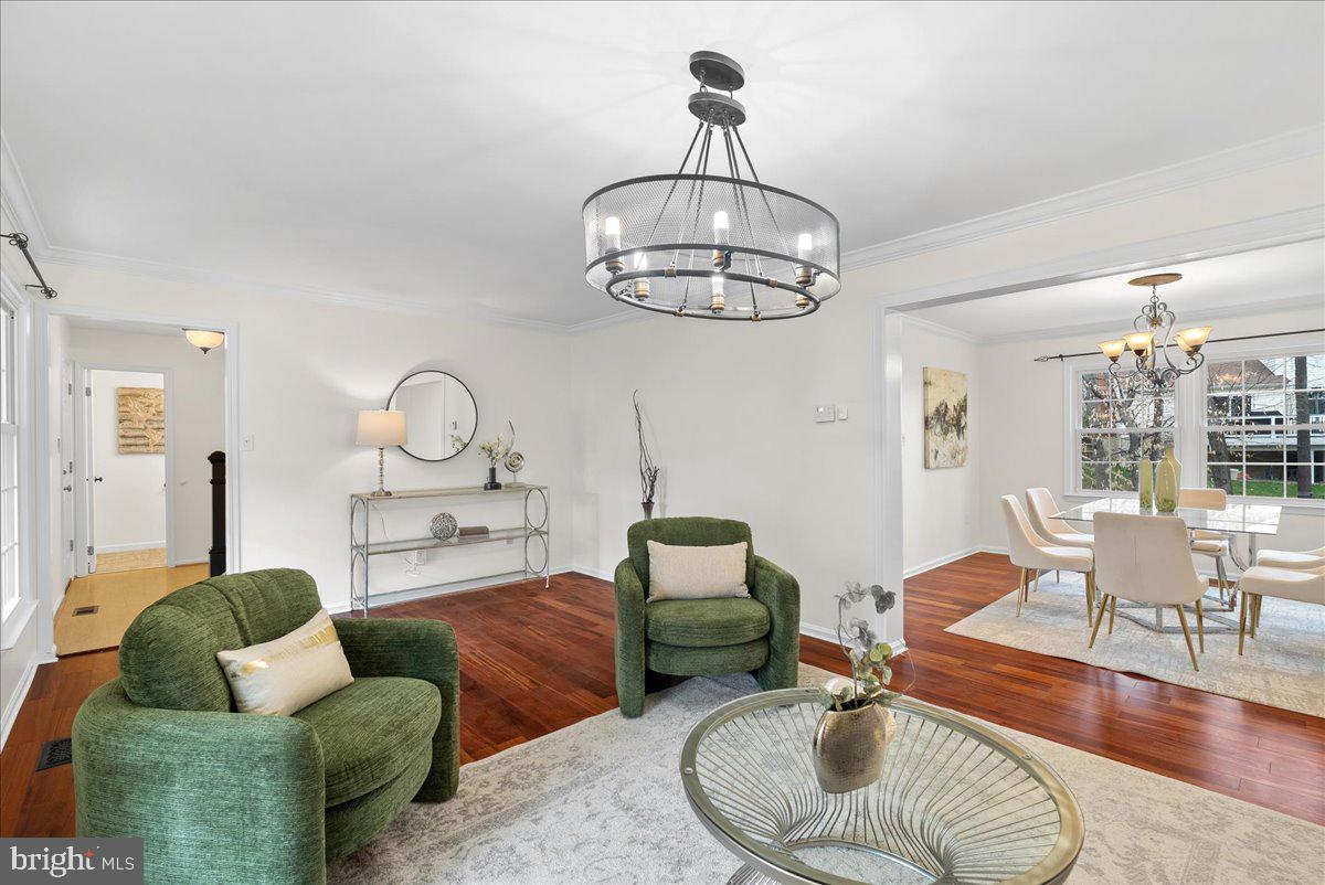7596 Ruxton Drive Springfield, VA 22153 - Photo 9 of 40 a living room with furniture and a chandelier