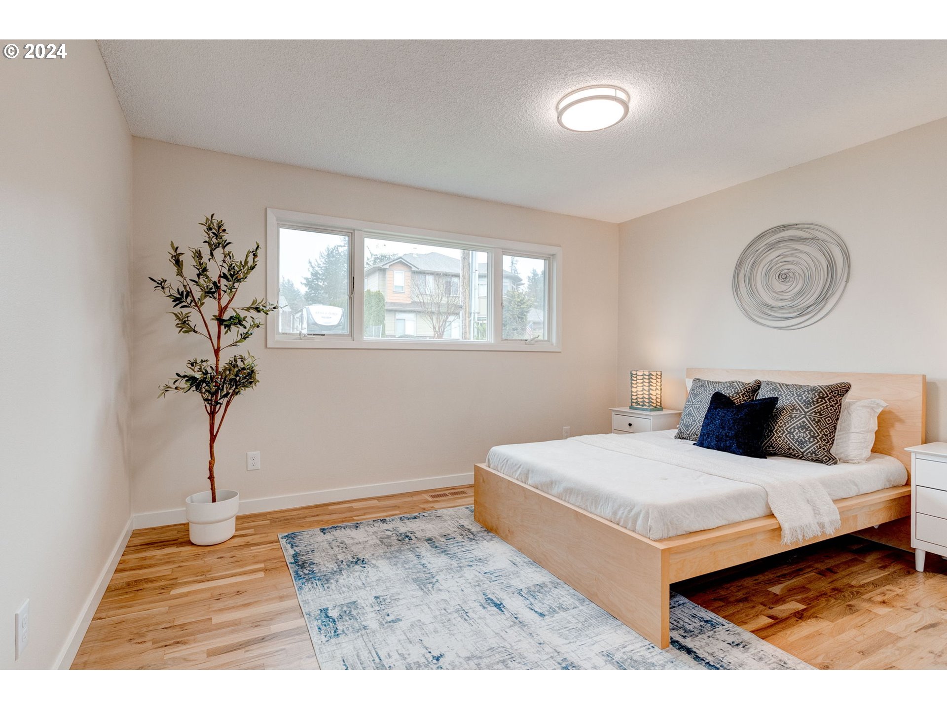 8815 Southwest 69th Avenue Portland, OR 97223 - Photo 14 of 36 a bedroom with a bed and a potted plant