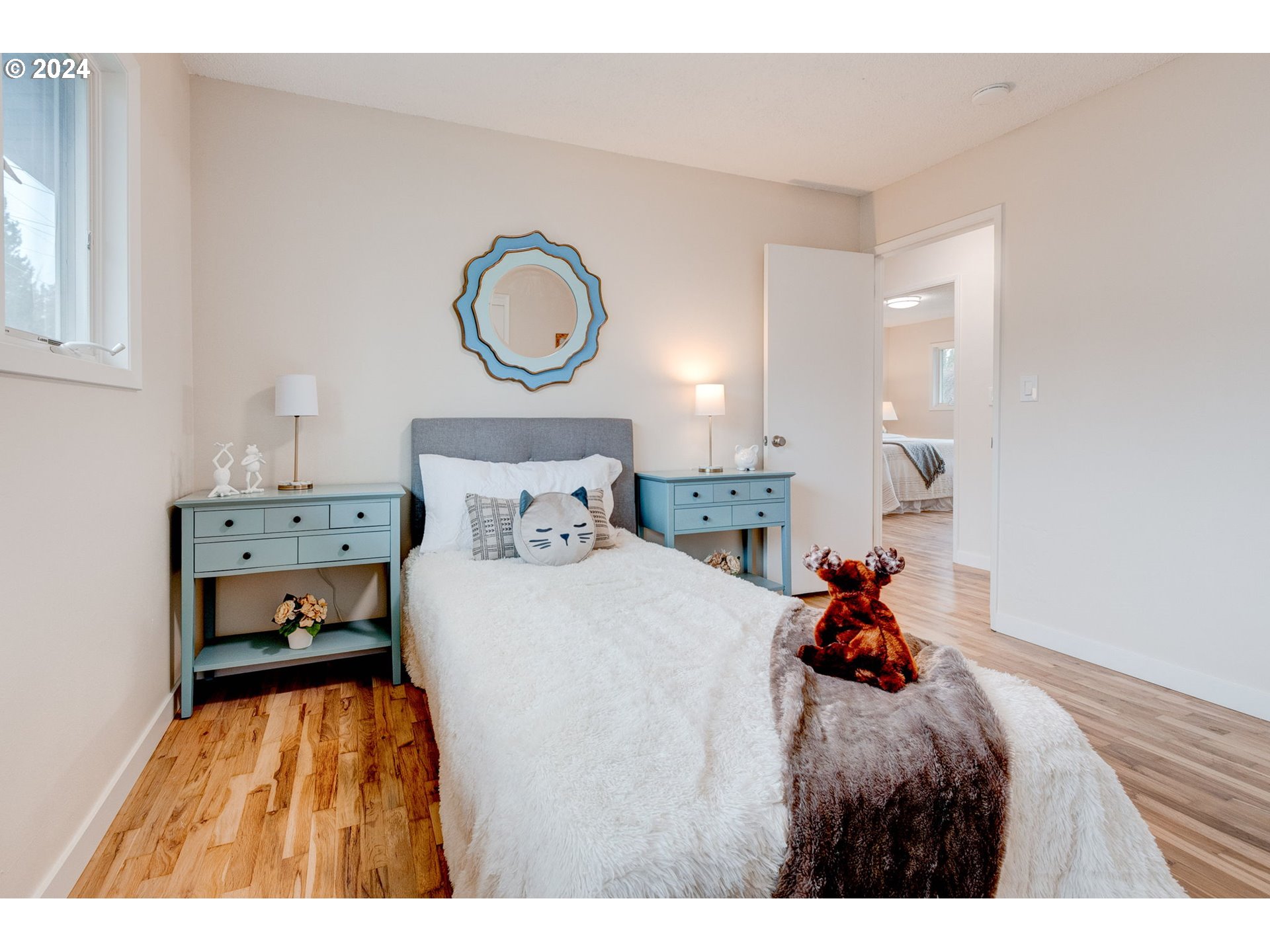 8815 Southwest 69th Avenue Portland, OR 97223 - Photo 17 of 36 a bedroom with a bed and a window