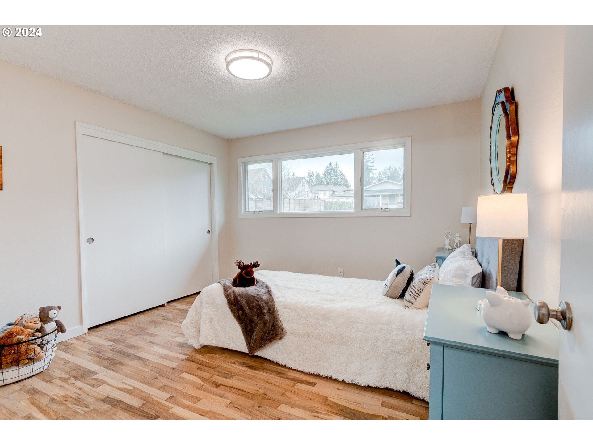 8815 Southwest 69th Avenue Portland, OR 97223 - Photo 18 of 36 a bedroom with a bed and a dresser