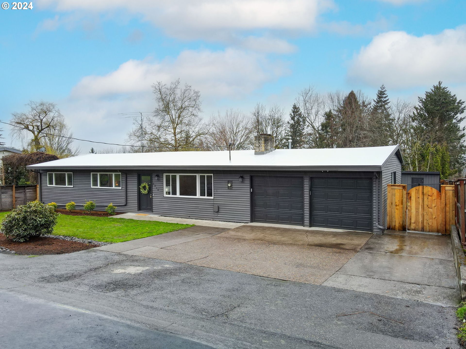 8815 Southwest 69th Avenue Portland, OR 97223 - Photo 2 of 36 a front view of a house with a yard and trees