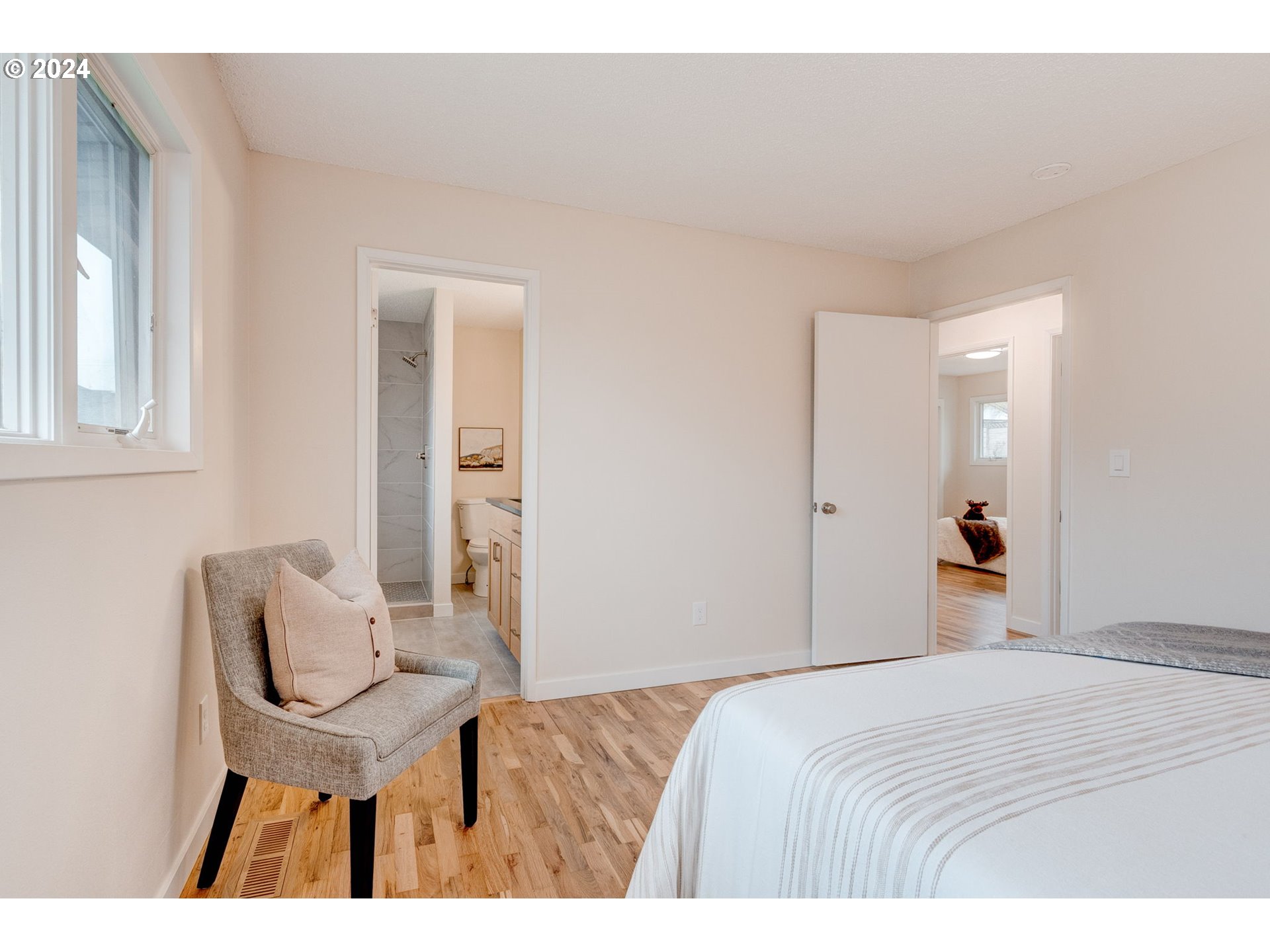 8815 Southwest 69th Avenue Portland, OR 97223 - Photo 21 of 36 a bedroom with a bed and chair