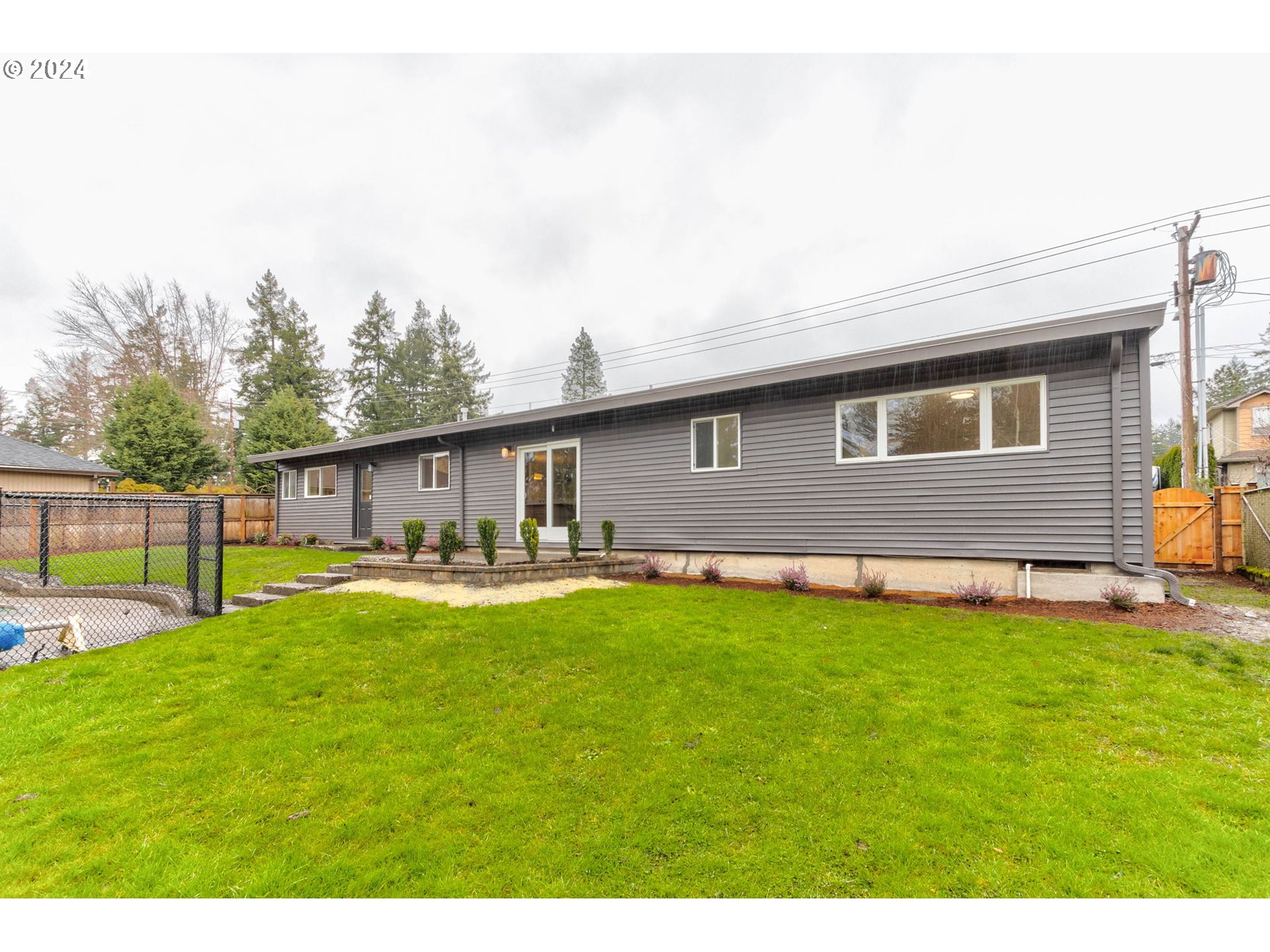 8815 Southwest 69th Avenue Portland, OR 97223 - Photo 27 of 36 a view of a house with a yard and sitting area