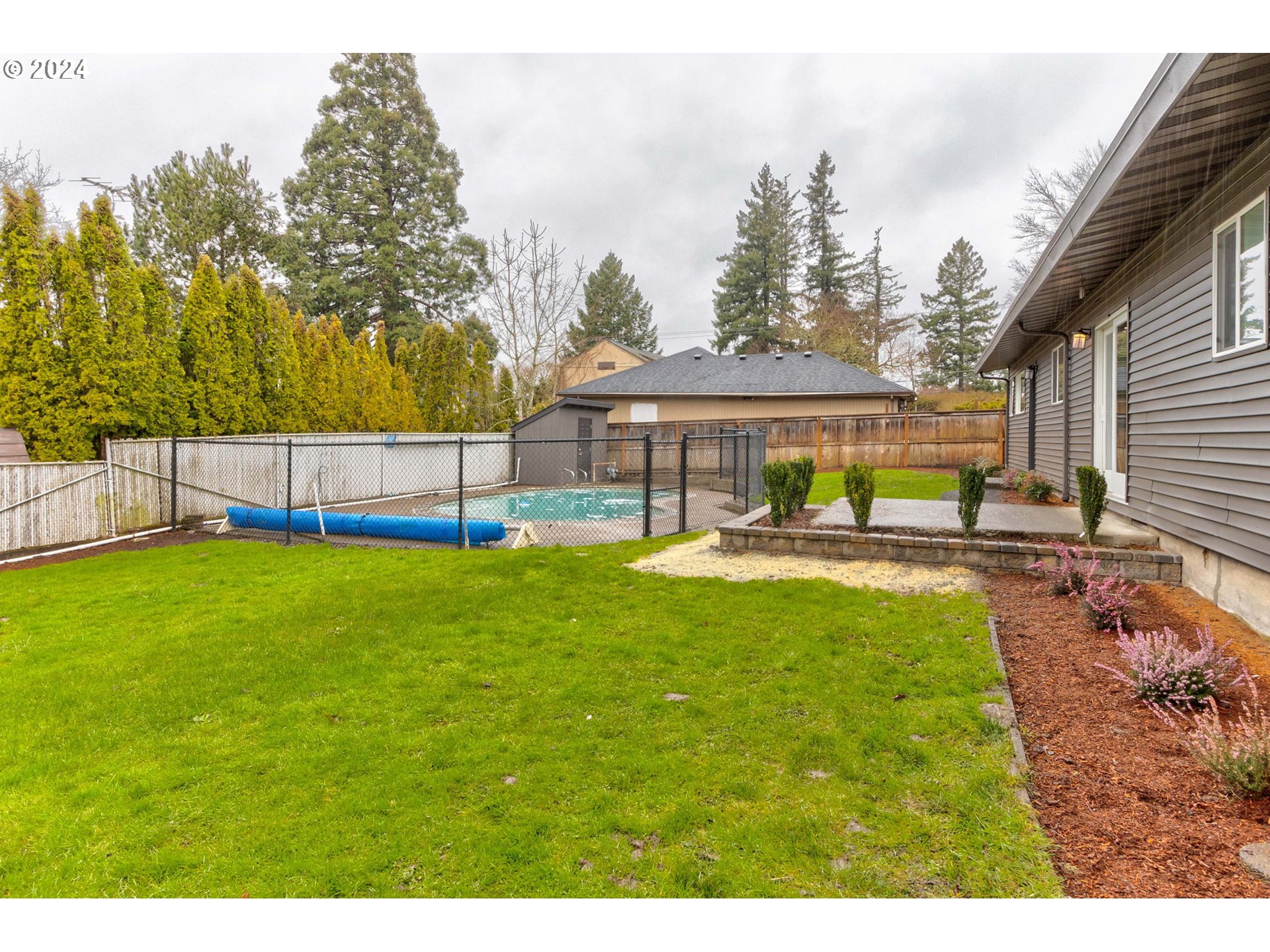 8815 Southwest 69th Avenue Portland, OR 97223 - Photo 29 of 36 a swimming pool view with a seating space and a garden view