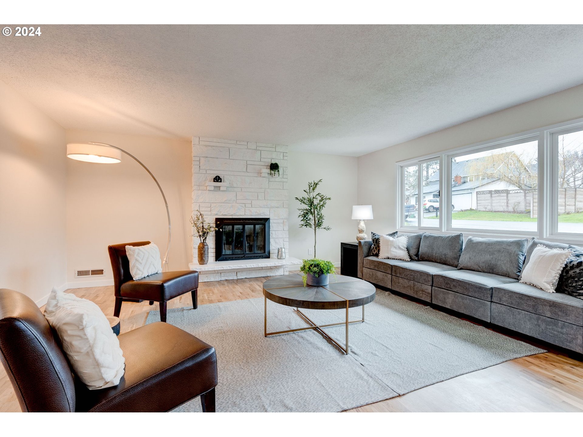 8815 Southwest 69th Avenue Portland, OR 97223 - Photo 3 of 36 a living room with furniture a fireplace and a table