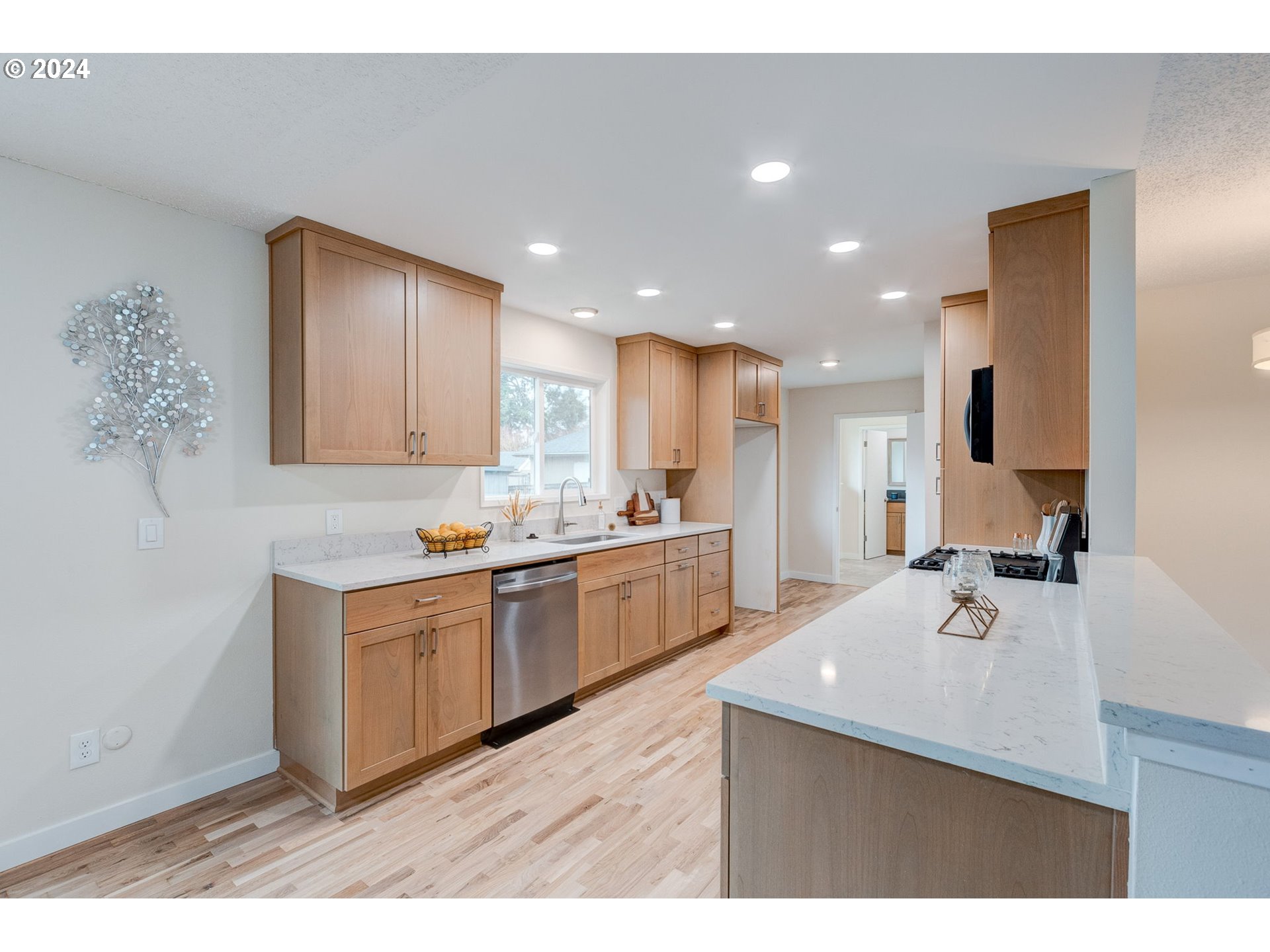 8815 Southwest 69th Avenue Portland, OR 97223 - Photo 9 of 36 a kitchen with kitchen island a sink stainless steel appliances and cabinets