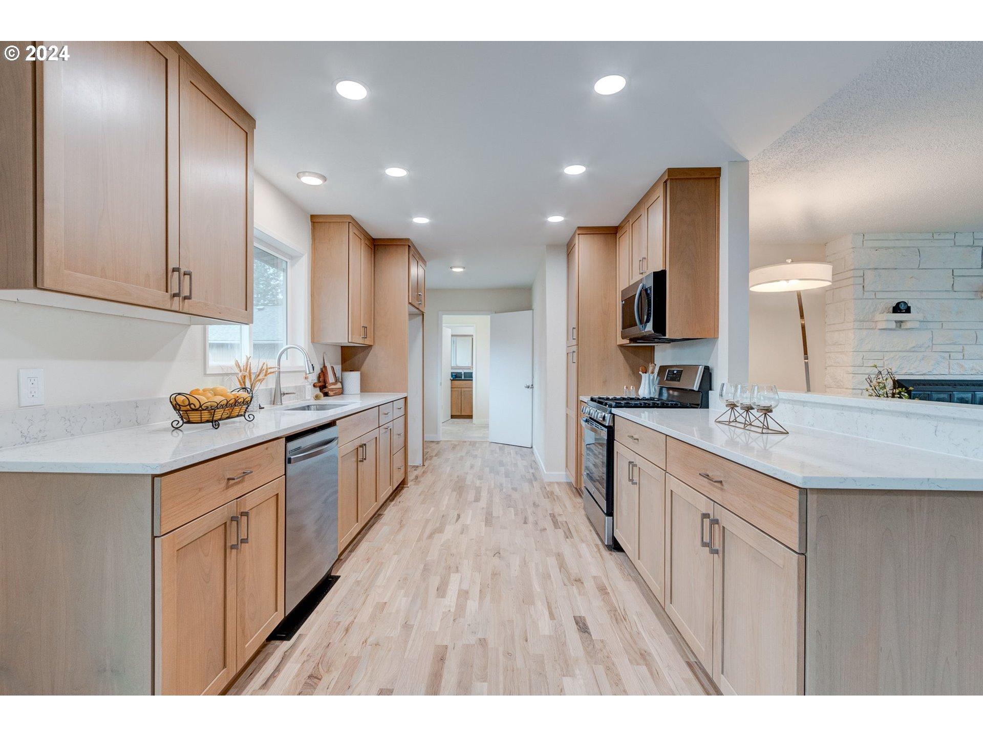 8815 Southwest 69th Avenue Portland, OR 97223 - Photo 10 of 36 a large kitchen with stainless steel appliances kitchen island granite countertop a large counter top a sink a stove and a refrigerator