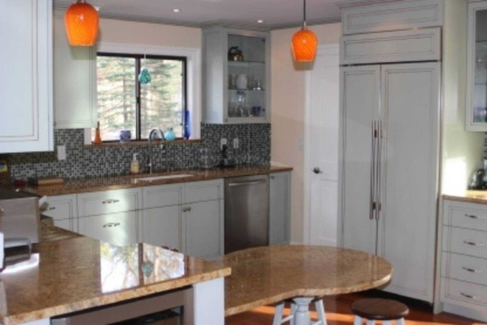 13 Diane Drive East Hampton, NY 11937 - Photo 3 of 7 a kitchen with stainless steel appliances granite countertop a sink a stove a dining table and chairs