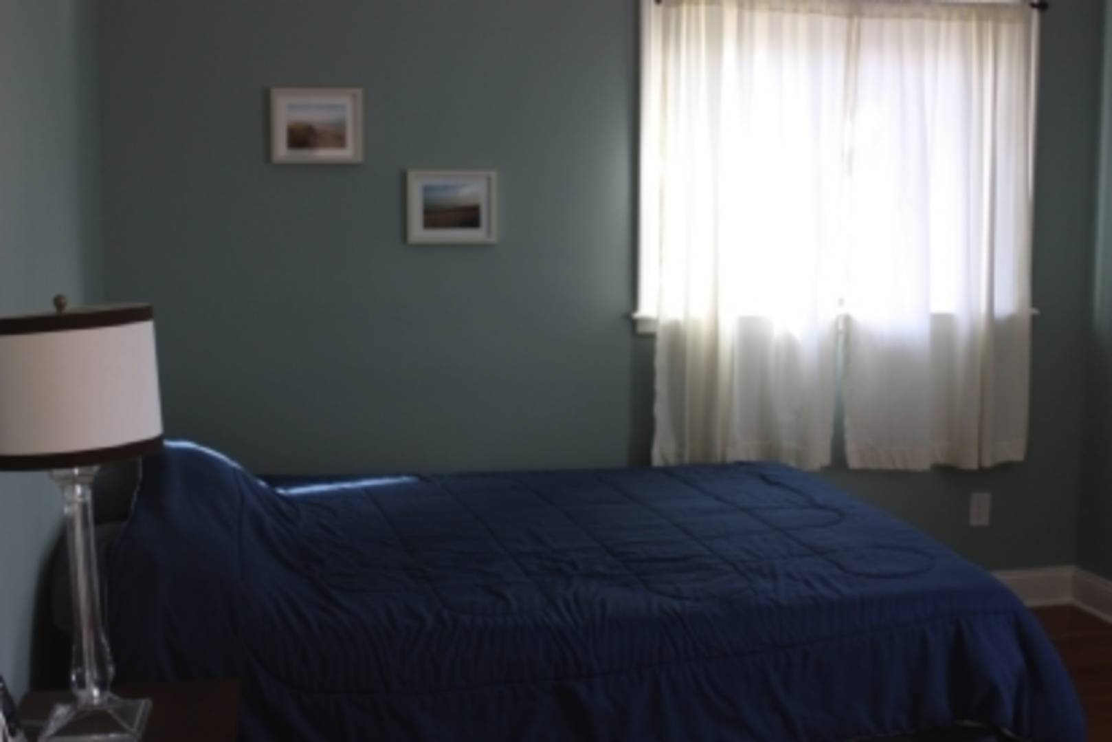 13 Diane Drive East Hampton, NY 11937 - Photo 7 of 7 a bed sitting in a bedroom next to a window