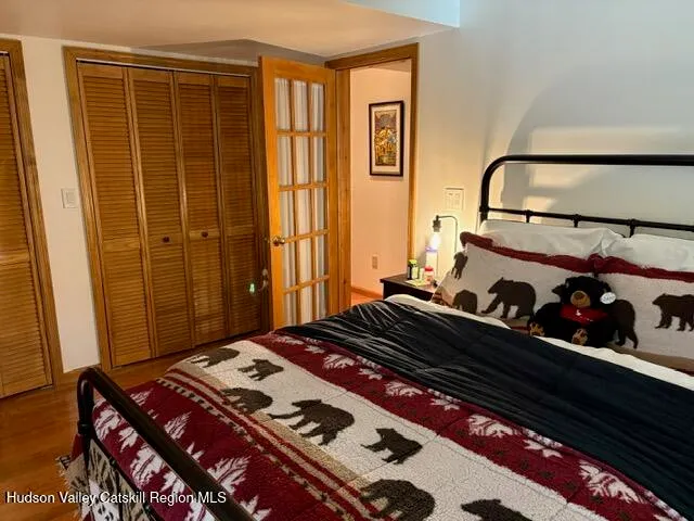 a bed sitting in a bedroom next to a window