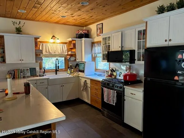 a kitchen with a sink cabinets and wooden floor