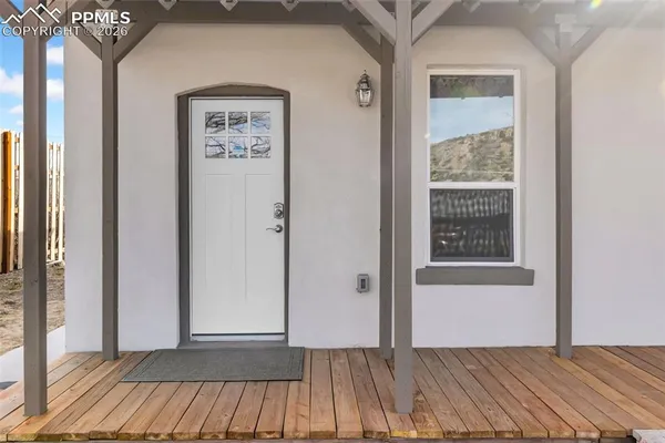 a view of a room with wooden floor and windows