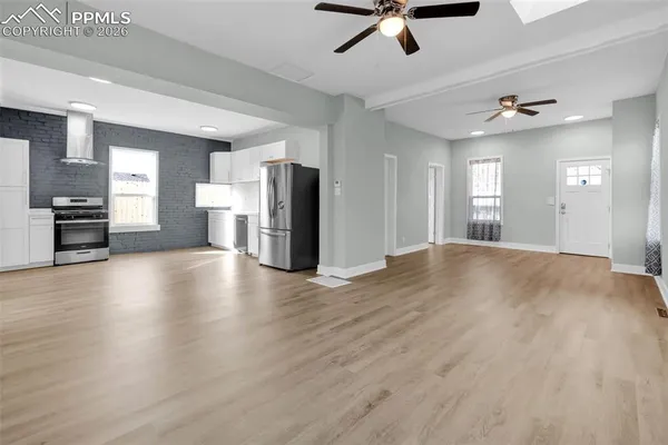 a view of a kitchen with a stove cabinets and wooden floor