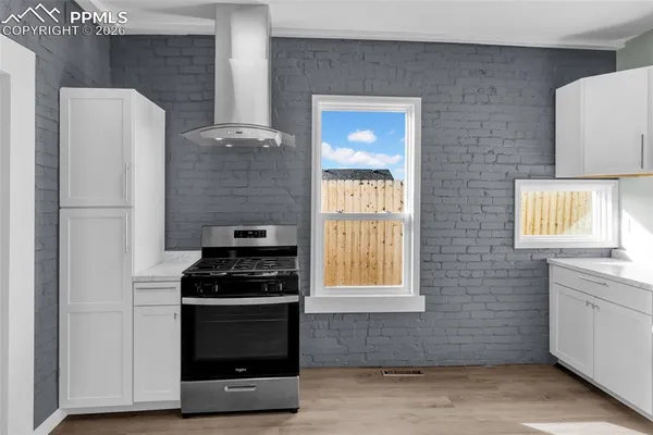 a kitchen with stainless steel appliances a stove and a refrigerator