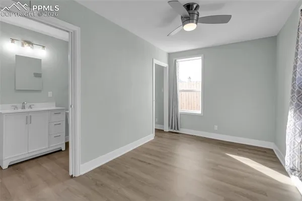 a view of entryway with kitchen and hardwood floor