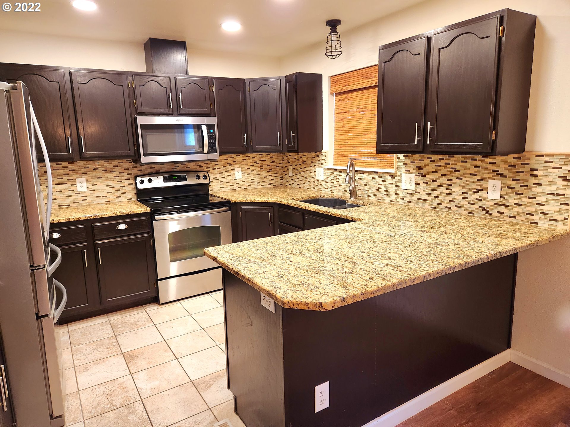3785 Southwest Marshall Place Pendleton, OR 97801 - Photo 3 of 20 a kitchen with stainless steel appliances kitchen island granite countertop a sink stove and refrigerator