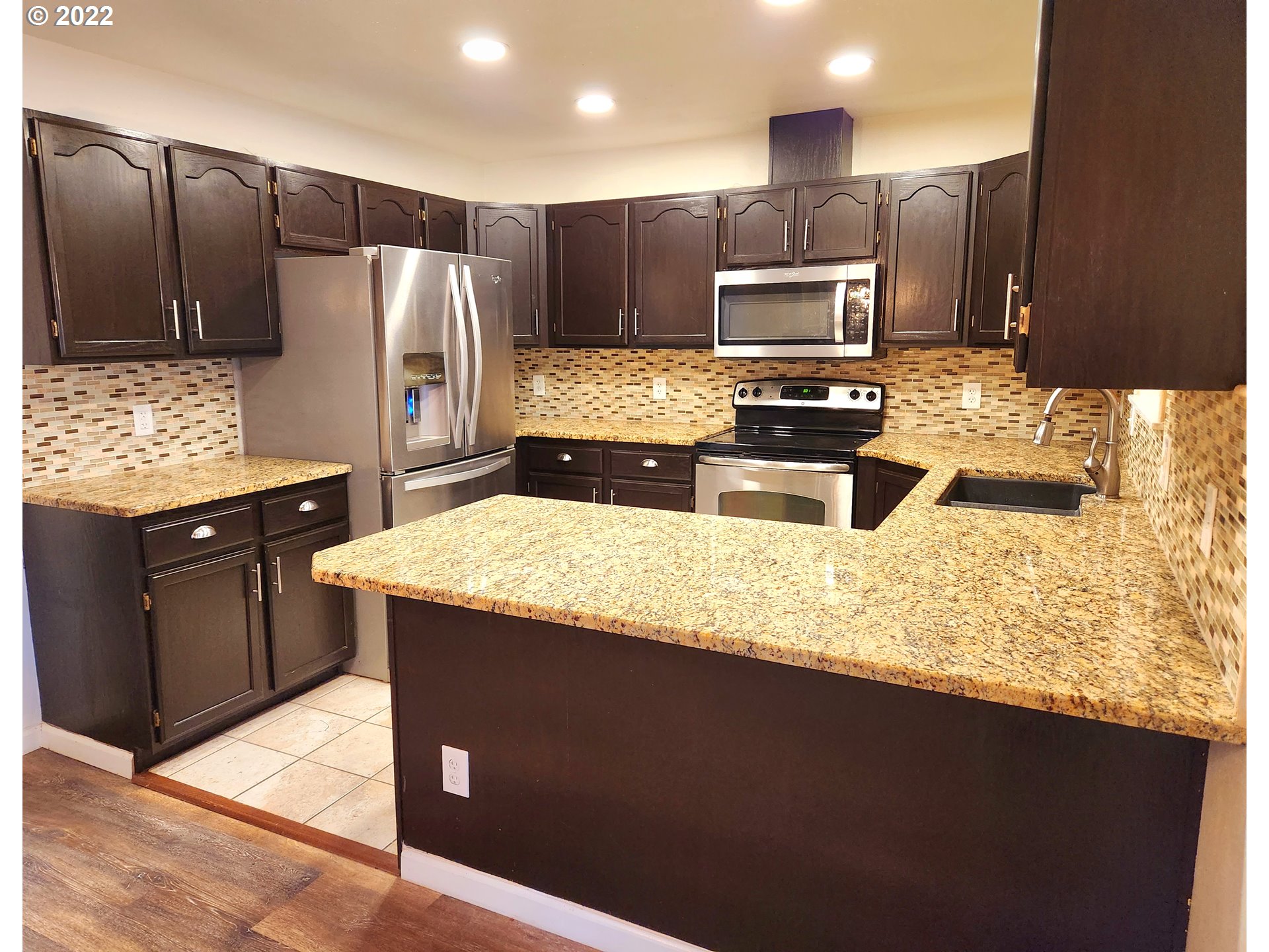 3785 Southwest Marshall Place Pendleton, OR 97801 - Photo 4 of 20 a kitchen with stainless steel appliances granite countertop a sink stove and refrigerator