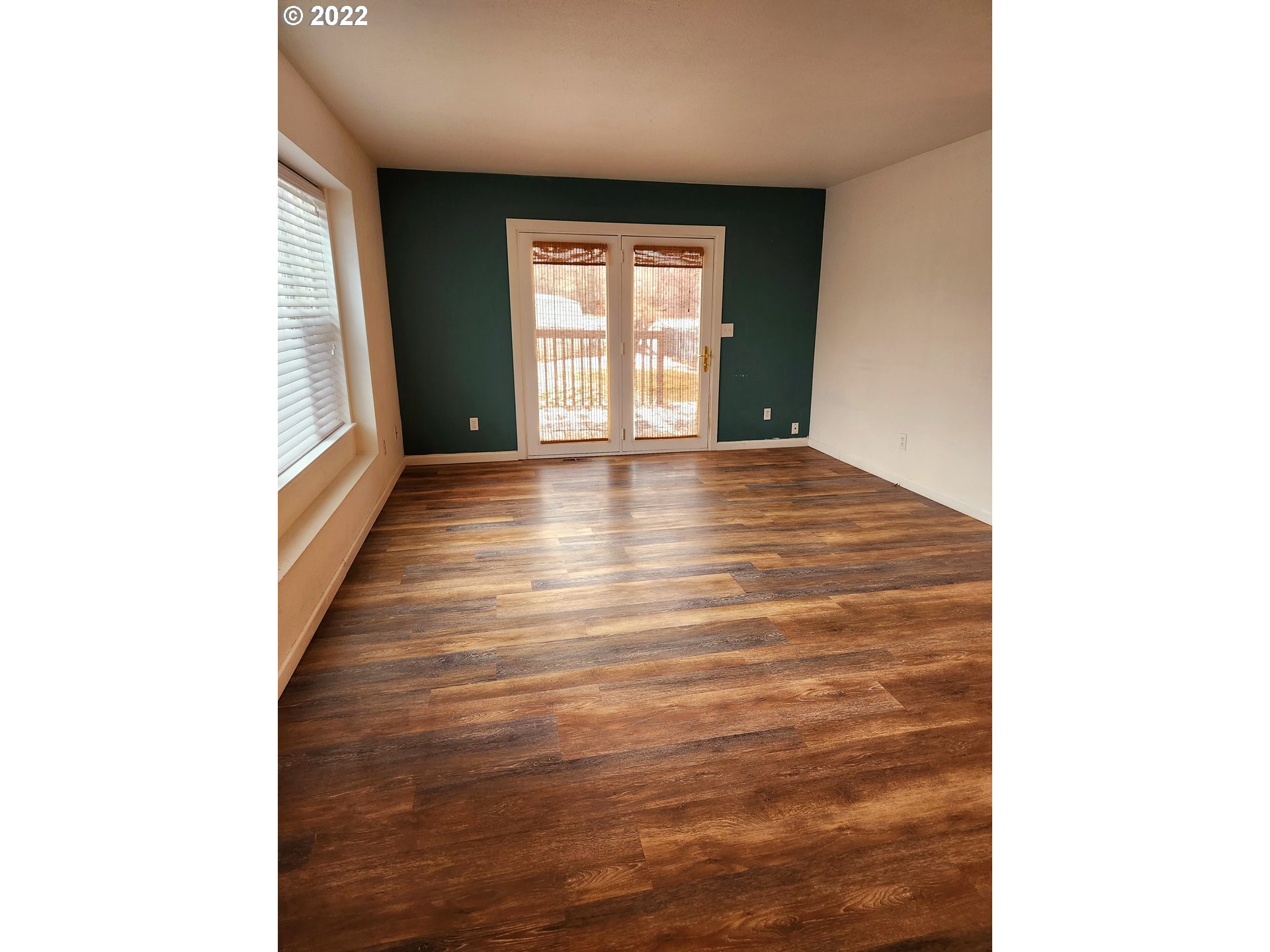 3785 Southwest Marshall Place Pendleton, OR 97801 - Photo 5 of 20 a view of an empty room with wooden floor and a window