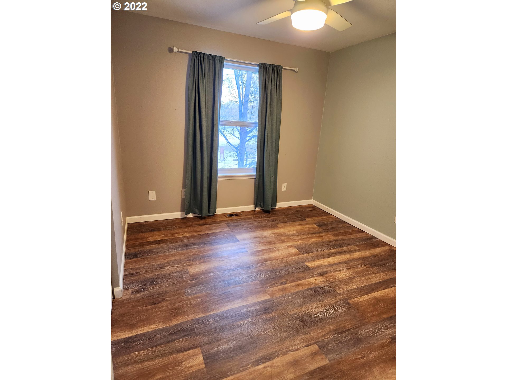 3785 Southwest Marshall Place Pendleton, OR 97801 - Photo 10 of 20 a view of an empty room with window and wooden floor