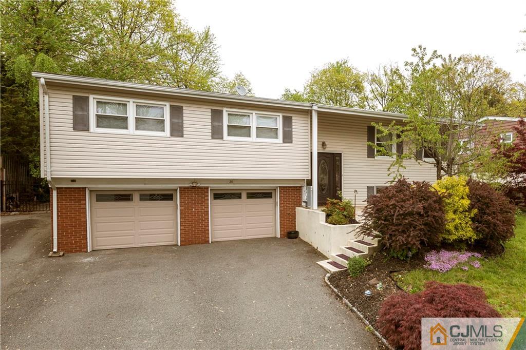 26 Peake Road Edison, NJ 08837 - Photo 2 of 23 a front view of a house with a garage