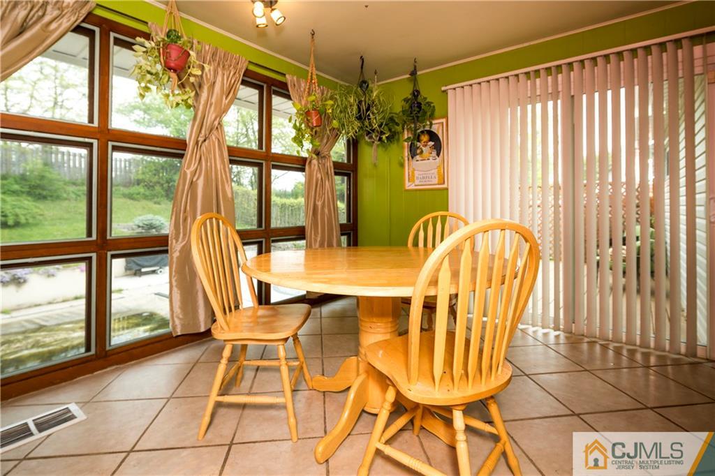 26 Peake Road Edison, NJ 08837 - Photo 11 of 23 a dining room with furniture and large windows