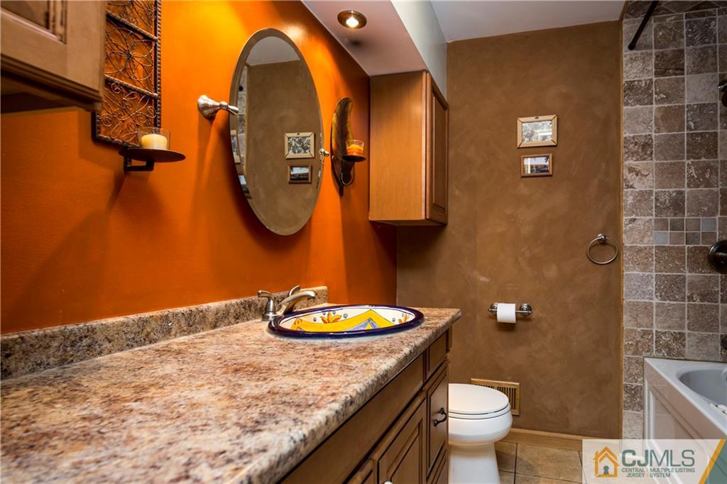 26 Peake Road Edison, NJ 08837 - Photo 13 of 23 a bathroom with a granite countertop toilet sink and mirror