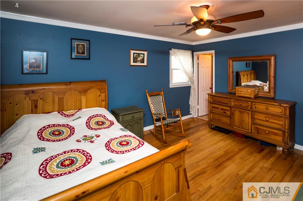 26 Peake Road Edison, NJ 08837 - Photo 16 of 23 a bedroom with a bed and a dresser in it