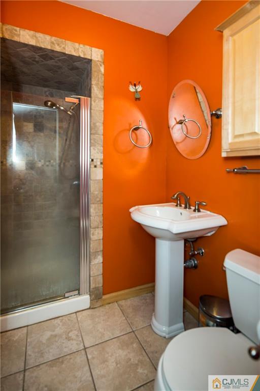 26 Peake Road Edison, NJ 08837 - Photo 17 of 23 a bathroom with a sink a toilet and shower