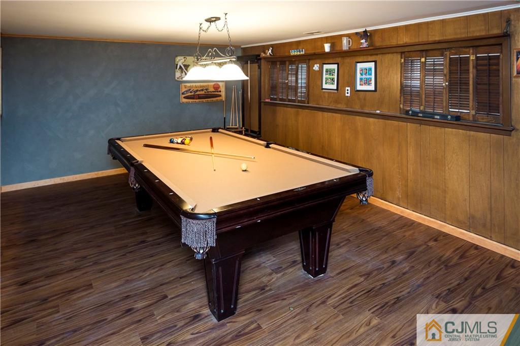 26 Peake Road Edison, NJ 08837 - Photo 19 of 23 a room with wooden floor pool table and window