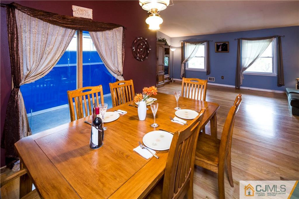26 Peake Road Edison, NJ 08837 - Photo 8 of 23 a dining room with furniture and wooden floor