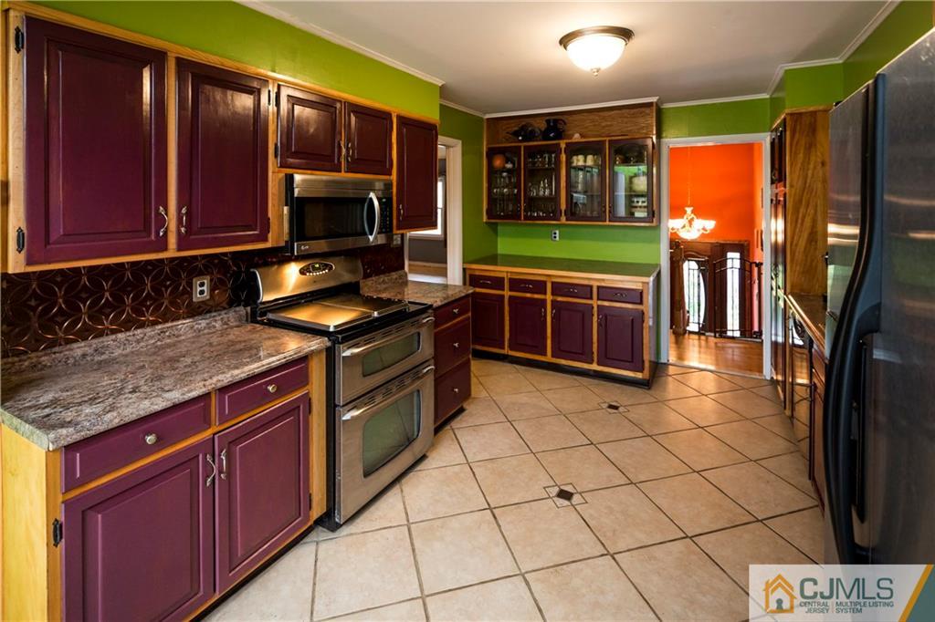 26 Peake Road Edison, NJ 08837 - Photo 9 of 23 a kitchen with stainless steel appliances granite countertop a stove a sink and a microwave