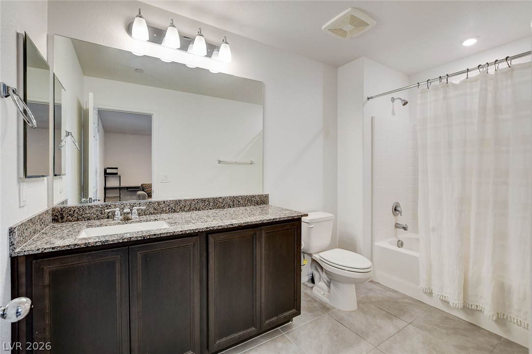 484 Filaree Place Henderson, NV 89015 - Photo 39 of 71 This bright bathroom features a spacious vanity with elegant granite counters and a clean, inviting tub/shower combination.