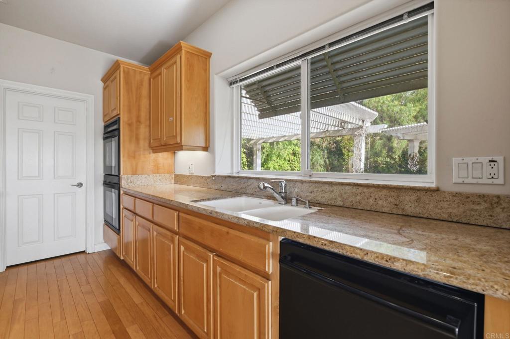 2596 Green Canyon Road Fallbrook, CA 92028 - Photo 12 of 74 a kitchen with granite countertop a sink and a window