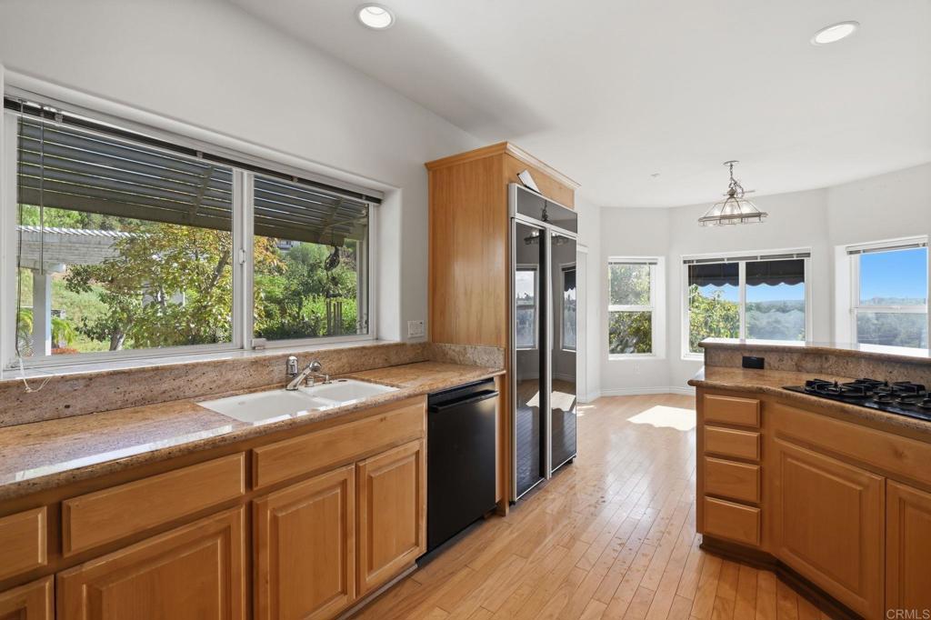 2596 Green Canyon Road Fallbrook, CA 92028 - Photo 13 of 74 a kitchen with stainless steel appliances granite countertop a sink stove and refrigerator