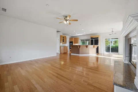 a view of balcony with wooden floor and fence