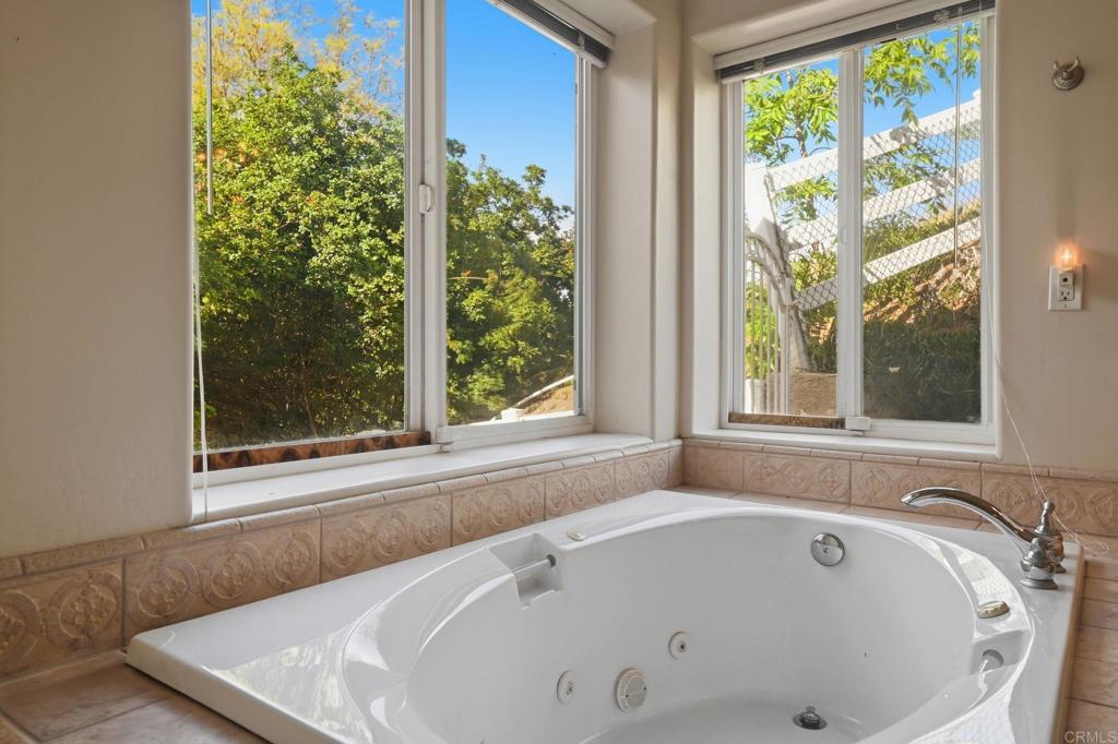 2596 Green Canyon Road Fallbrook, CA 92028 - Photo 31 of 74 a bathroom with bathtub and window