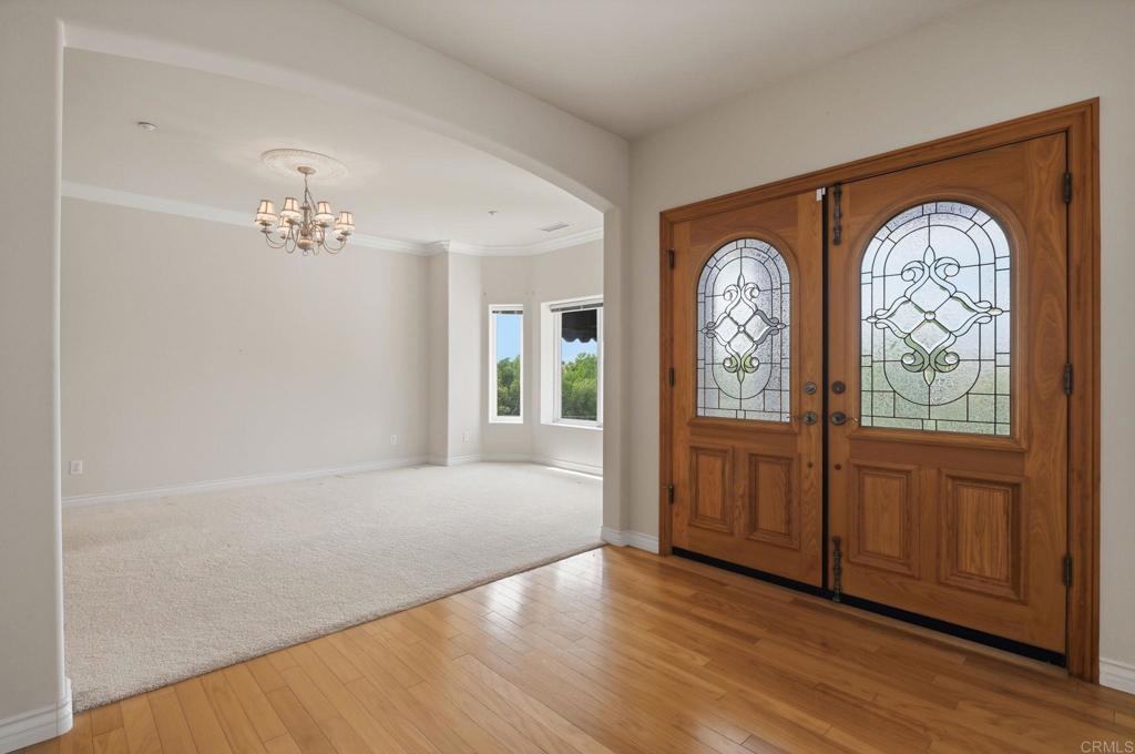 2596 Green Canyon Road Fallbrook, CA 92028 - Photo 5 of 74 an empty room with wooden floor fan and windows
