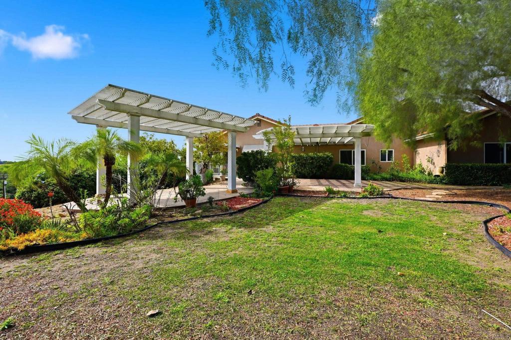 2596 Green Canyon Road Fallbrook, CA 92028 - Photo 59 of 74 a view of a patio with couches table and chairs and potted plants