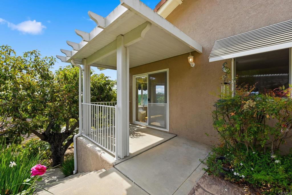 2596 Green Canyon Road Fallbrook, CA 92028 - Photo 62 of 74 a view of a balcony with floor to ceiling window and potted plants