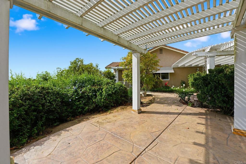 2596 Green Canyon Road Fallbrook, CA 92028 - Photo 65 of 74 a view of a patio with table and chairs potted plants with wooden fence