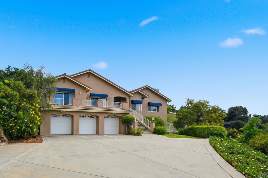 2596 Green Canyon Road Fallbrook, CA 92028 - Photo 66 of 74 a front view of a house with a yard and garage