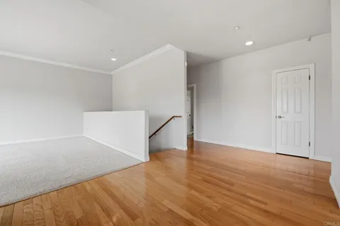 a view of a living room and kitchen with furniture wooden floor and windows