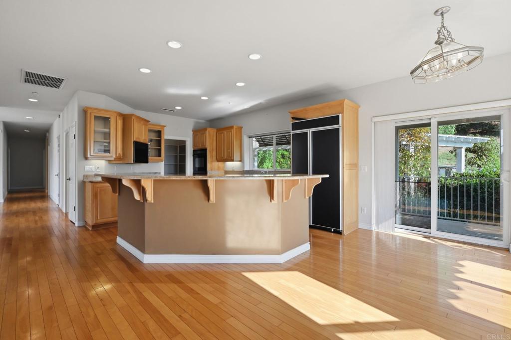 2596 Green Canyon Road Fallbrook, CA 92028 - Photo 10 of 74 a view of a living room and kitchen with furniture wooden floor and windows