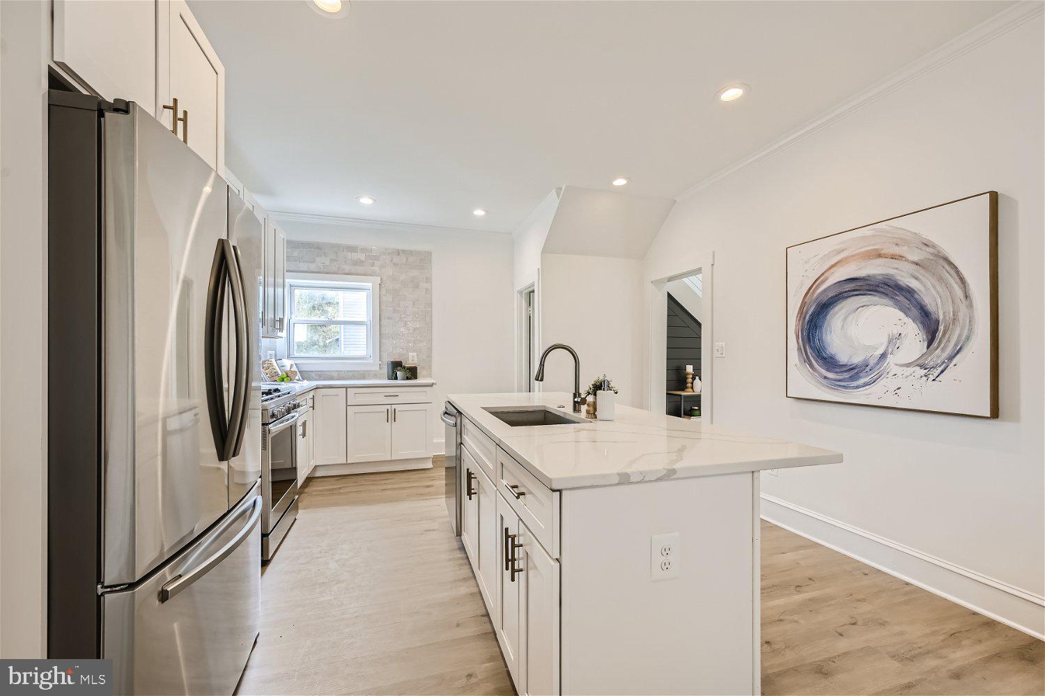 611 Coleraine Road Baltimore, MD 21229 - Photo 19 of 33 a kitchen with white cabinets and refrigerator