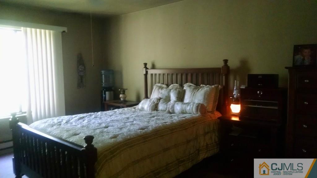 90 Arrowood Road Englishtown, NJ 07726 - Photo 8 of 16 a bed sitting in a bedroom next to a window