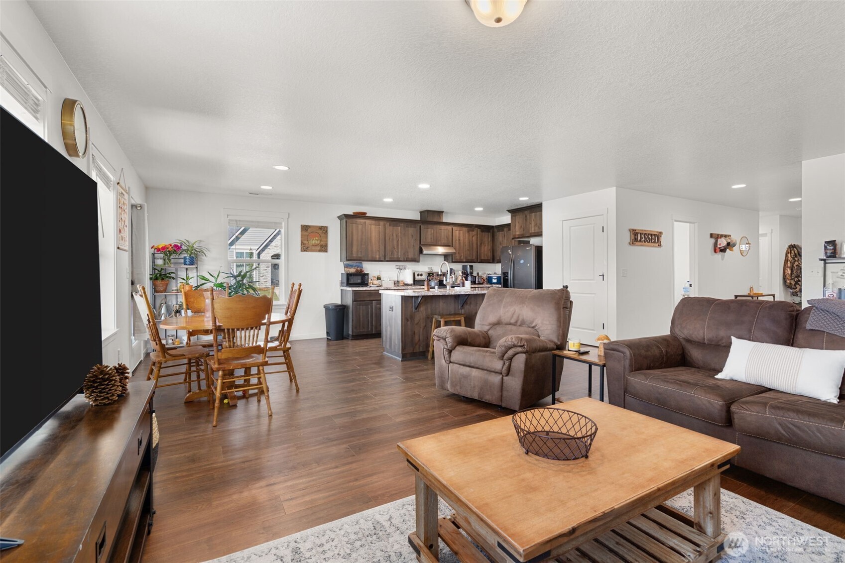 401 Cardinal Avenue Winlock, WA 98596 - Photo 8 of 39 a living room with furniture and a dining table with kitchen view