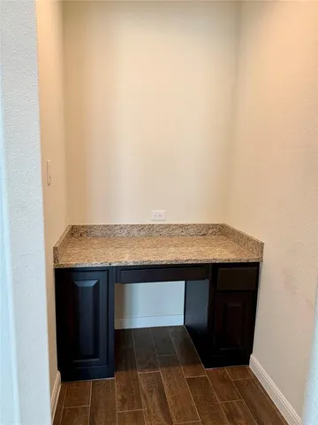 a room with a sink and cabinets